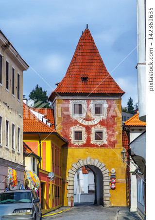 Budejovice Gate tower in Cesky Krumlov, Czech Republic. Historical renaissance tower with red tiled roof under cloudy sky Budejovice Gate tower in Cesky Krumlov, Czech Republic. Historical renaissance tower with red tiled roof under cloudy sky 142361635