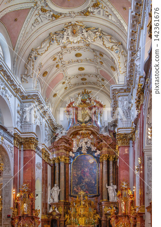 Interior of St. Ignatius Church in Prague, Czech Republic. Baroque architecture with golden ornaments and religious art 142361676