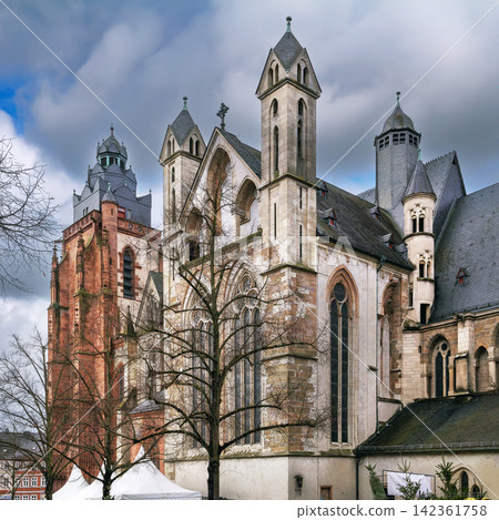 Wetzlar Cathedral with red sandstone tower in Germany. Ancient religious architecture under cloudy sky and no people around Wetzlar Cathedral with red sandstone tower in Germany. Ancient religious architecture under cloudy sky and no people around 142361758