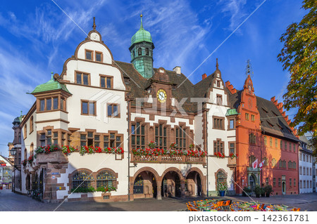 Old and New City Hall buildings in Freiburg, Germany. Renaissance architecture of the town hall square under blue sky Old and New City Hall buildings in Freiburg, Germany. Renaissance architecture of the town hall square under blue sky 142361781