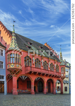 Historical Merchants Hall on Munsterplatz in Freiburg, Germany. Renaissance architecture of the facade under blue sky Historical Merchants Hall on Munsterplatz in Freiburg, Germany. Renaissance architecture of the facade under blue sky 142361782