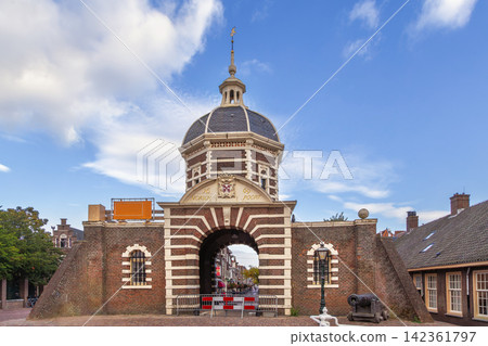 View of Morspoort city gate in Leiden, Netherlands. Historical stone architecture with a dome under cloudy sky and clouds 142361797