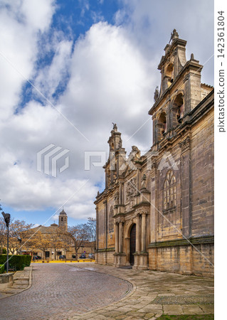 Exterior of Basilica de Santa Maria de los Reales Alcazares in Ubeda, Spain. Historic architecture under cloudy sky at daytime Exterior of Basilica de Santa Maria de los Reales Alcazares in Ubeda, Spain. Historic architecture under cloudy sky at daytime 142361804