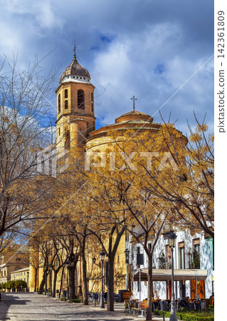 View of Holy Chapel of the Saviour from the embankment in Ubeda, Spain. Renaissance architecture under cloudy sky at daytime View of Holy Chapel of the Saviour from the embankment in Ubeda, Spain. Renaissance architecture under cloudy sky at daytime 142361809