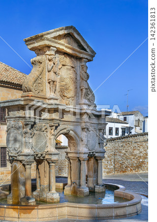 Santa Maria Fountain in the cathedral square of Baeza, Spain. Renaissance stone architecture under blue sky at daytime Santa Maria Fountain in the cathedral square of Baeza, Spain. Renaissance stone architecture under blue sky at daytime 142361813