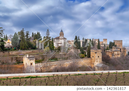 View of Alhambra fortress from Generalife gardens in Granada, Spain. Moorish architecture under cloudy sky at daytime View of Alhambra fortress from Generalife gardens in Granada, Spain. Moorish architecture under cloudy sky at daytime 142361817