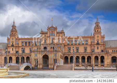 Central building of Plaza de Espana in Seville Spain with grand arches. Renaissance Revival architecture under cloudy sky Central building of Plaza de Espana in Seville Spain with grand arches. Renaissance Revival architecture under cloudy sky 142361861