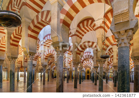 Interior of Mosque Cathedral of Cordoba, Spain. Great Hall with red and white striped arches, historic architecture, no people Interior of Mosque Cathedral of Cordoba, Spain. Great Hall with red and white striped arches, historic architecture, no people 142361877