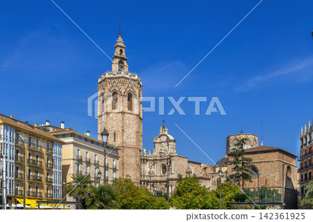 View of Valencia Cathedral from Plaza de la Reina, Spain, wide angle. Historic baroque facade and bell tower under sunny sky View of Valencia Cathedral from Plaza de la Reina, Spain, wide angle. Historic baroque facade and bell tower under sunny sky 142361925
