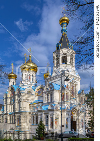 Church of St. Peter and Paul in Karlovy Vary, Czech Republic. Perspective view, spring blossom trees, blue sky, daylight Church of St. Peter and Paul in Karlovy Vary, Czech Republic. Perspective view, spring blossom trees, blue sky, daylight 142361946