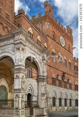 Cappella di Piazza and Palazzo Pubblico in Siena Italy view of the facade. Gothic architecture under sunny blue sky 142361970