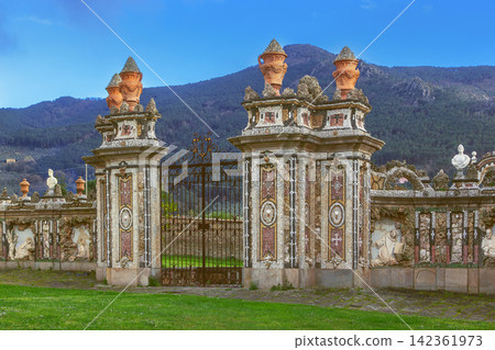 Pisa Charterhouse in Calci Italy view of the side gates with sculpture. Baroque architecture under sunny blue sky Pisa Charterhouse in Calci Italy view of the side gates with sculpture. Baroque architecture under sunny blue sky 142361973