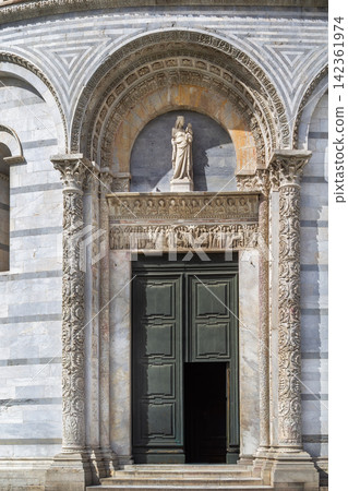Pisa Baptistry in Italy view of the main entrance portal. Romanesque architecture with soft daylight on marble facade Pisa Baptistry in Italy view of the main entrance portal. Romanesque architecture with soft daylight on marble facade 142361974