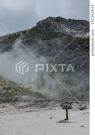 White smoke rising from the fumaroles of Atosanupuri (Sulfur Mountain) in Teshikaga Town, Hokkaido, Japan. White smoke rising from the fumaroles of Atosanupuri (Sulfur Mountain) in Teshikaga Town, Hokkaido, Japan. 142362655