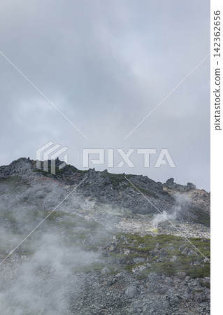 White smoke rising from the fumaroles of Atosanupuri (Sulfur Mountain) in Teshikaga Town, Hokkaido, Japan. White smoke rising from the fumaroles of Atosanupuri (Sulfur Mountain) in Teshikaga Town, Hokkaido, Japan. 142362656