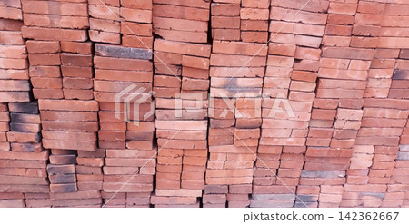 A stack of red bricks for construction. 142362667