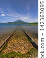 Japan, Hokkaido, Kushiro City: A view of Lake Akan in its fresh greenery, Mount Oakan, and the lakeside railway. 142363095