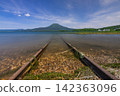 Japan, Hokkaido, Kushiro City: A view of Lake Akan in its fresh greenery, Mount Oakan, and the lakeside railway. 142363096