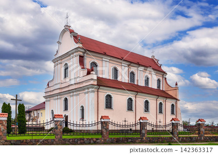 St John the Baptist church in Golshany, Belarus. Three quarter view of baroque architecture under partly cloudy sky St John the Baptist church in Golshany, Belarus. Three quarter view of baroque architecture under partly cloudy sky 142363317