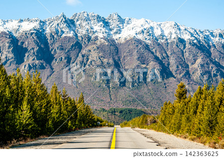 Scenic road trip highway leading towards snow capped Andes mountains in Patagonia, Argentina Scenic road trip highway leading towards snow capped Andes mountains in Patagonia, Argentina 142363625