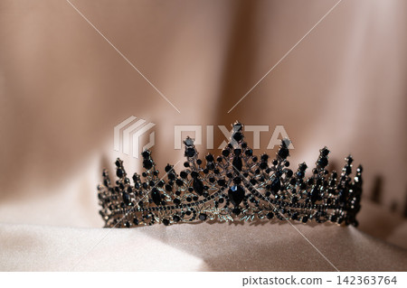 Elegant Black Crystal Crown, Tiara on Beige Gold Fabric. 142363764