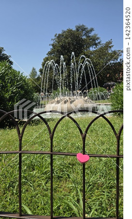 A heart-shaped lock on a fence near a fountain in central Verona, Italy. Concepts of tourism, love, expressions of affection, European tours, Valentine's Day A heart-shaped lock on a fence near a fountain in central Verona, Italy. Concepts of tourism, love, expressions of affection, European tours, Valentine's Day 142364520