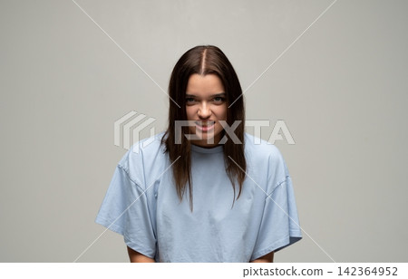 Young woman feeling frustration and anger, showing aggressive emotion with a fierce facial expression Young woman feeling frustration and anger, showing aggressive emotion with a fierce facial expression 142364952