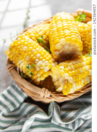 Fresh corn cobs in basket with morning light Fresh corn cobs in basket with morning light 142364957