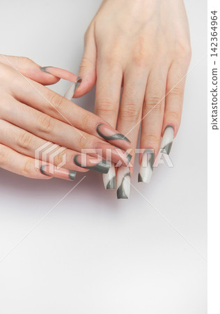 Woman's hands showing creative nail art design Woman's hands showing creative nail art design 142364964