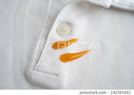 Dirty tomato sauce stain removal or ketchup on cloth accident to wash with washing powder, cleaning housework. Dirty tomato sauce stain removal or ketchup on cloth accident to wash with washing powder, cleaning housework. 142365881