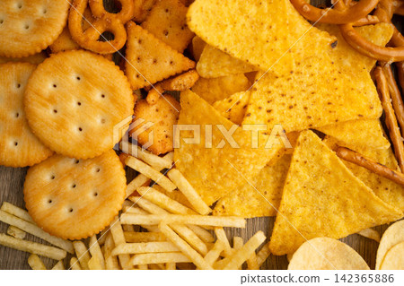 Mix of variety snack chips pretzel and cracker, junk crunchy food. Mix of variety snack chips pretzel and cracker, junk crunchy food. 142365886