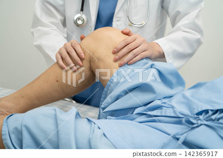 Doctor checking Asian elderly woman patient with scar knee replacement surgery in hospital. Doctor checking Asian elderly woman patient with scar knee replacement surgery in hospital. 142365917