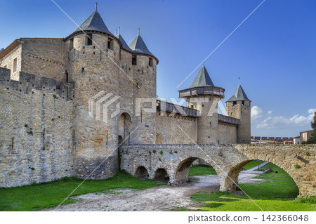 Three quarter view of Cite de Carcassonne in France, showing the towers and bridge. Medieval castle fortress architecture 142366048