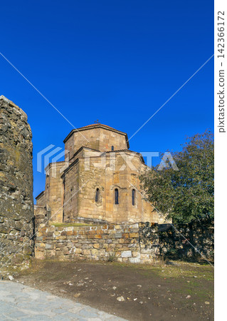 Jvari Monastery near Mtskheta, Georgia, featuring an ancient tetraconch apse facade. Sunny day with clear blue sky Jvari Monastery near Mtskheta, Georgia, featuring an ancient tetraconch apse facade. Sunny day with clear blue sky 142366172
