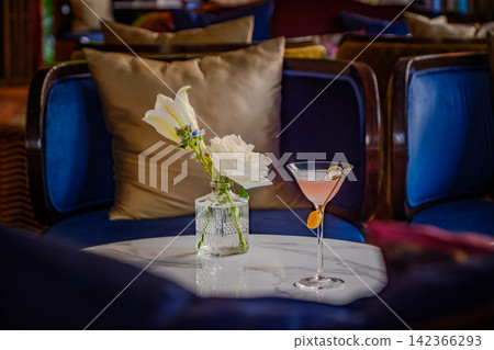 a beautiful pink clear cocktail drink in martini glass serve on table of the bar a beautiful pink clear cocktail drink in martini glass serve on table of the bar 142366293