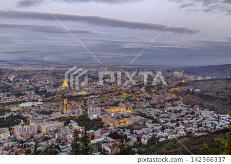 Panoramic view of Tbilisi from Mtatsminda mountain, Georgia. Evening scenic cityscape with soft lighting, travel style Panoramic view of Tbilisi from Mtatsminda mountain, Georgia. Evening scenic cityscape with soft lighting, travel style 142366337