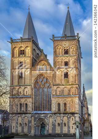 Historic facade of Xanten Cathedral stands in Xanten, Germany. Daylight with a partly cloudy sky Historic facade of Xanten Cathedral stands in Xanten, Germany. Daylight with a partly cloudy sky 142366342