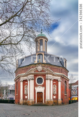 Main facade of St Clement church in Munster, Germany. Winter afternoon partly cloudy light Main facade of St Clement church in Munster, Germany. Winter afternoon partly cloudy light 142366386