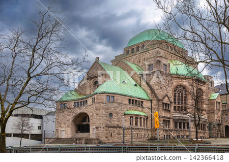 Old Synagogue in Essen, Germany, three quarter view. Historic art nouveau and Byzantine style architecture under cloudy winter sky. Old Synagogue in Essen, Germany, three quarter view. Historic art nouveau and Byzantine style architecture under cloudy winter sky. 142366418