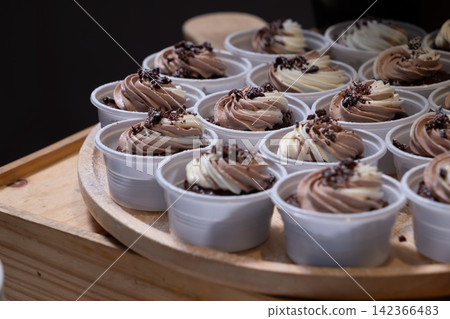 chocolate cupcakes on wooden plate in wedding party reception chocolate cupcakes on wooden plate in wedding party reception 142366483