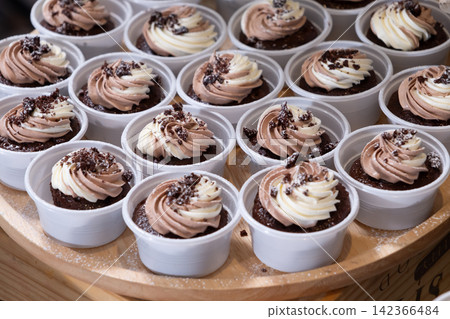chocolate cupcakes on wooden plate in wedding party reception chocolate cupcakes on wooden plate in wedding party reception 142366484