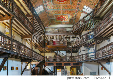 Three tiered wooden galleries in Saint Etienne church interior in Espelette, France. Inside view of historic basque nave Three tiered wooden galleries in Saint Etienne church interior in Espelette, France. Inside view of historic basque nave 142366591