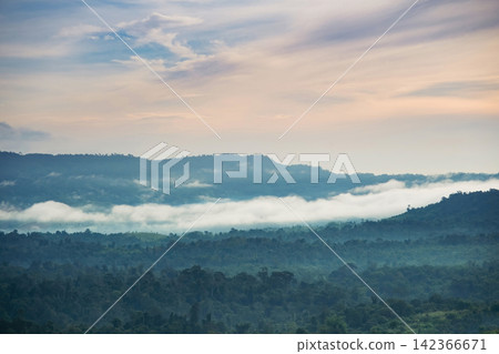 morning mist cover the forest villages between mountains with cloudy orange sunrise sky morning mist cover the forest villages between mountains with cloudy orange sunrise sky 142366671