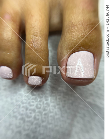 Close up pedicure toes with pastel pink gel polish and water droplets Close up pedicure toes with pastel pink gel polish and water droplets 142366744
