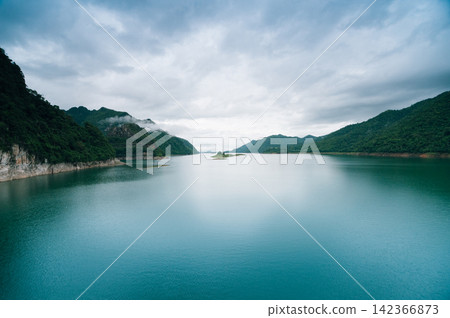 a scenery of large lake reservoir with cloudy sky in rainy season a scenery of large lake reservoir with cloudy sky in rainy season 142366873