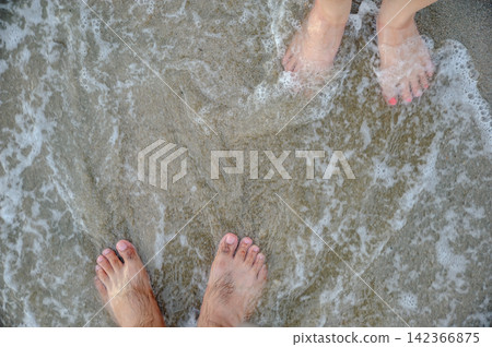two feets of man and woman stand together on sand, abstract photograph, background, couple two feets of man and woman stand together on sand, abstract photograph, background, couple 142366875