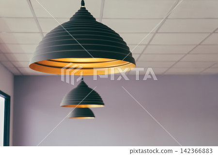 vintage style hanged ceiling lamp warm orange tone light color bulb light with dark blue tone dirty concrete background wall vintage style hanged ceiling lamp warm orange tone light color bulb light with dark blue tone dirty concrete background wall 142366883