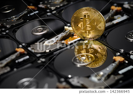 one bitcoin isolated standing belong naked hard disk drives with reflection on data disc for background wallpaper in internet business finance crypto currency banking scene one bitcoin isolated standing belong naked hard disk drives with reflection on data disc for background wallpaper in internet business finance crypto currency banking scene 142366945