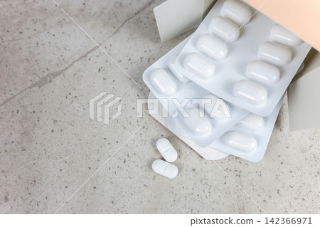 White pills and cardboard on the nature stone background. Healthcare concept. Space for text. 142366971
