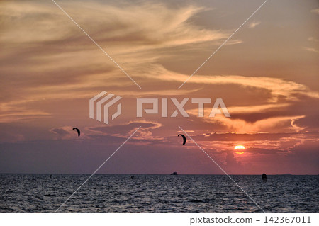 red twilight sky of sunset scene with cloudy sky over the open ocean with many waves red twilight sky of sunset scene with cloudy sky over the open ocean with many waves 142367011